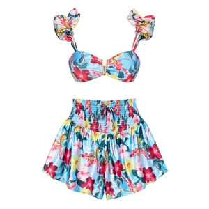 Détail d'un bikini bleu floral avec bretelles à volants et boucle en V en métal