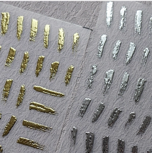 Detailed macro view of 3D metallic gold and silver textured nail art stickers