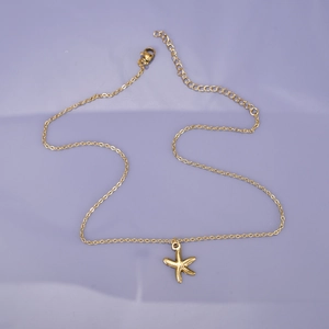 Detail of 18K gold starfish pendant on an adjustable stainless steel chain
