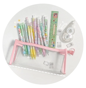 Pink zippered clear PVC pencil case filled with colorful stationery on white background