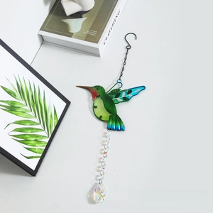Detail of metal hummingbird suncatcher with blue green wings and crystal prism pendant
