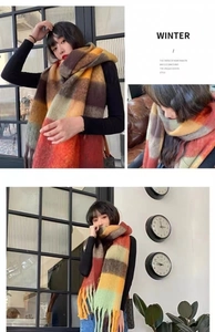 Close-up detail of soft rainbow plaid scarf featuring stylish fringe accents for winter