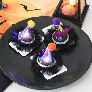 Close-up of three mini witch hats with sequins and LED lights on a black display tray