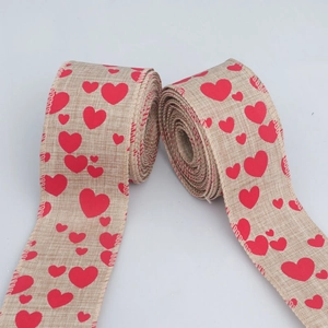 Close-up of burlap ribbon with red heart print and reinforced wired edges for DIY crafts