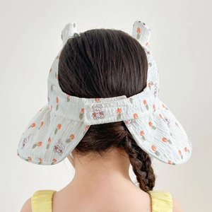 Detail of white kids sun hat featuring adjustable velcro closure and cute rabbit ears