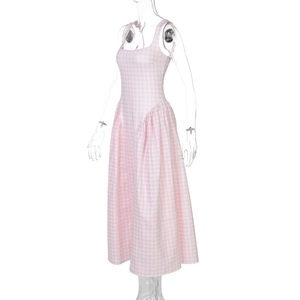 Close-up of pink plaid dress featuring a square neckline and sleeveless flared hem