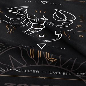 Macro detail of Scorpio zodiac tapestry fabric texture with gold celestial print