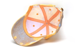 Detail view of cotton baseball cap interior with wash label and metal buckle adjustment