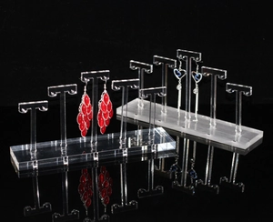 Macro view of transparent acrylic T-bar earring display stands with reflective surface