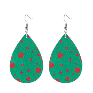 Detail of teardrop leather earrings with red polka dots on green and silver fish hooks