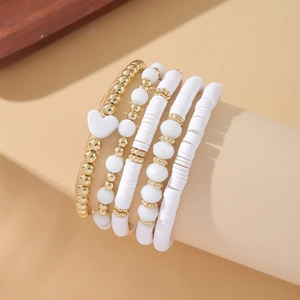 5-piece Bohemian stackable bracelet set with white heishi beads and gold heart charms