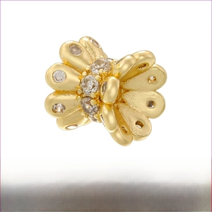 Macro detail of butterfly spacer bead in 18K gold plated brass with cubic zirconia stones