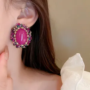 Vintage oval stud earrings featuring pink crystal stone and multicolored beaded trim