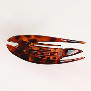 Close-up of tortoise shell pattern hair clip with internal teeth for secure grip