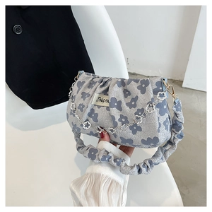 Detail of floral pleated shoulder bag with metallic chain and JINGPIN woven label
