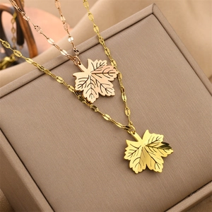 Maple leaf pendant necklace in gold and rose gold finish on premium jewelry box