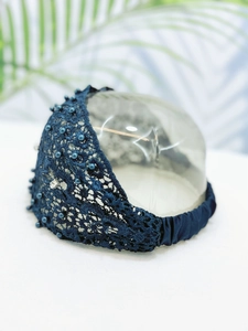 Detail of navy blue lace headband with pearls, rhinestones and elastic band