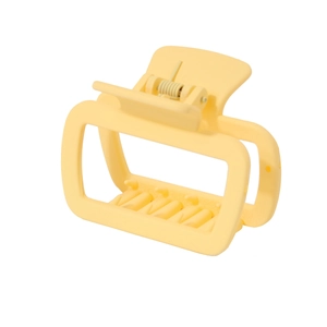 Detail view of large matte yellow square hair claw clip with strong metal spring