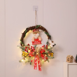 Detail of Christmas wreath with LED lights, pine needles, and Merry Christmas sign