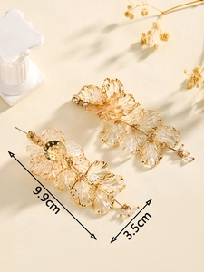 Detail shot showing dimensions of gold floral tassel earrings, 9.9cm length and 3.5cm width