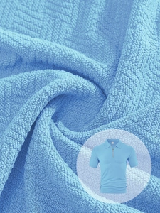 Macro texture of light blue waffle knit fabric and casual polo shirt with half-zipper