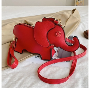 Detail of red elephant-shaped PU leather crossbody bag with tassel and gold zipper