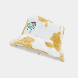 Cute plush cow print bucket hat in white and yellow with Sea Breeze embroidery patch