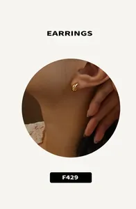 Detailed macro view of a minimalist 18K gold plated hoop earring worn by a model