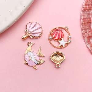 Set of four pink enamel ocean-themed charms including shell and fish for DIY jewelry