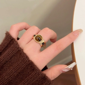 Vintage gold tiger eye ring with pleated geometric frame and black gemstone accents
