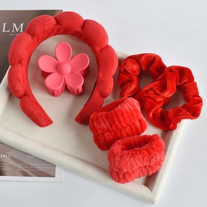 Detailed view of 6-piece red hair accessory set with headband and scrunchies