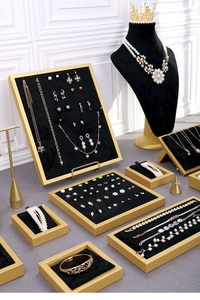 Detail of premium black velvet jewelry display stands with gold frames for shop counters