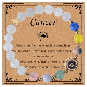 Detailed shot of handmade Cancer zodiac bracelet with blue beads and star charms