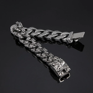 Detailed close-up of retro silver tiger head links on a heavy steel men's bracelet