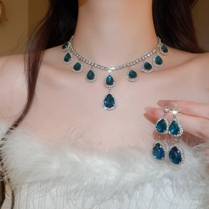 Detailed macro view of sparkling blue teardrop crystal necklace and matching earrings