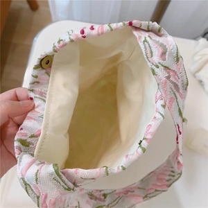 Detailed interior of pink floral tote showing lining, inner pocket and magnetic snap