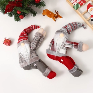 Set of two festive Christmas gnome dolls with plaid hats for holiday home decoration