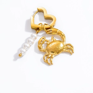Detailed shot of golden heart clasp with pearl charms and a sculpted crab pendant