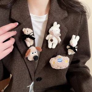 Cute flocked animal brooches featuring teddy bear and puppy on a stylish brown suit