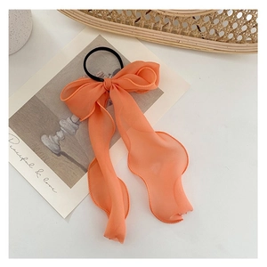 Elegant orange chiffon bow hair tie with long ribbons for a delicate fairy-like hairstyle