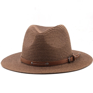 Detailed texture of brown straw fedora hat featuring a studded synthetic leather band