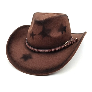 Detail of dark brown western cowboy hat with black star patterns and woven band strap