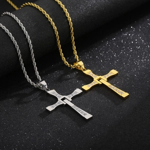 Detail of gold and silver cross pendants with zircon stones on twisted rope chains