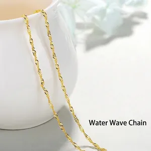 Minimalist golden water wave chain necklace displayed on elegant white ceramic