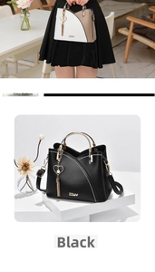 Detail of trendy handbag with golden circular handle and heart tassel charm in color options