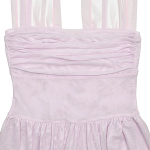 Close-up of pink pleated chiffon dress detailing the V-neck and ruffled fabric texture