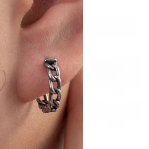 Macro shot of a vintage chain style stainless steel hoop earring with oxidized silver finish