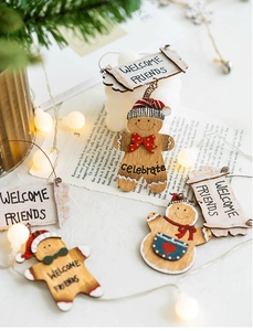 Wooden Christmas gingerbread man welcome friends door sign with festive rustic decorations