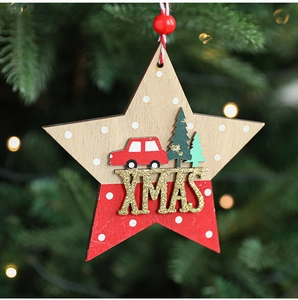 Macro shot of wooden star ornament with red truck, green tree and XMAS lettering