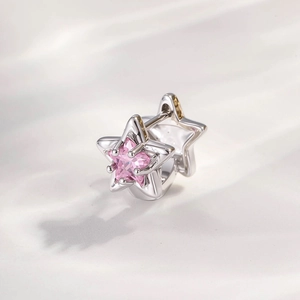 Minimalist silver hoop earring with pink star cubic zirconia on wavy background
